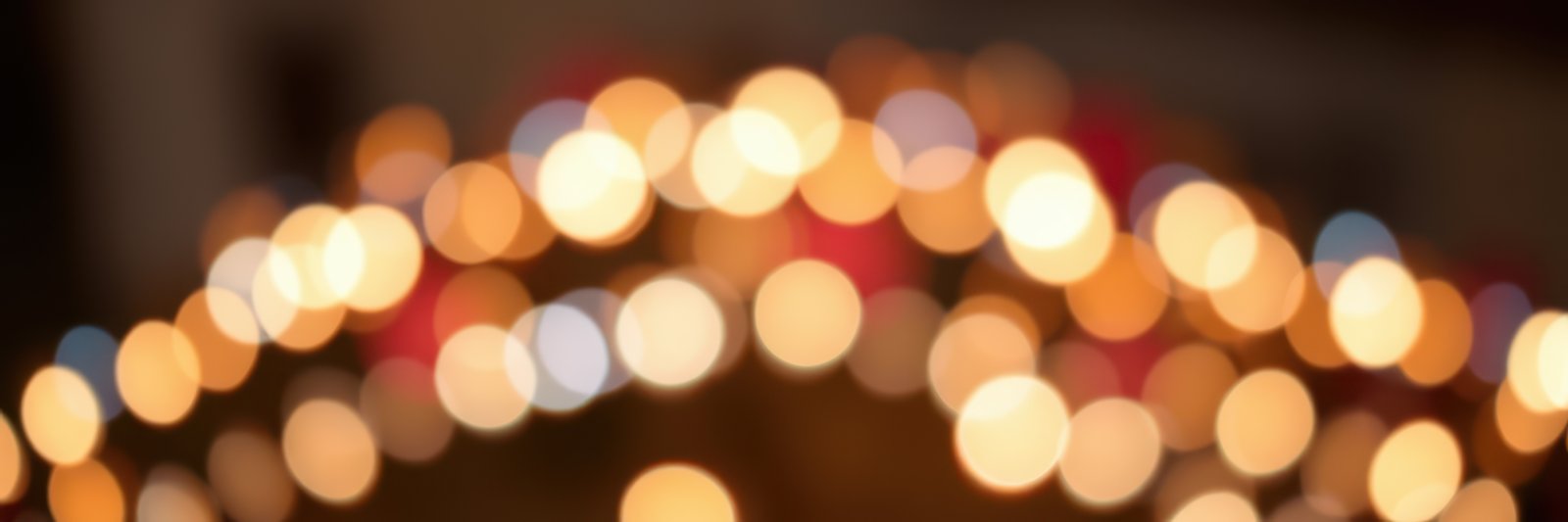 Festive lights illuminate a vibrant atmosphere at a winter celebration in a charming town square